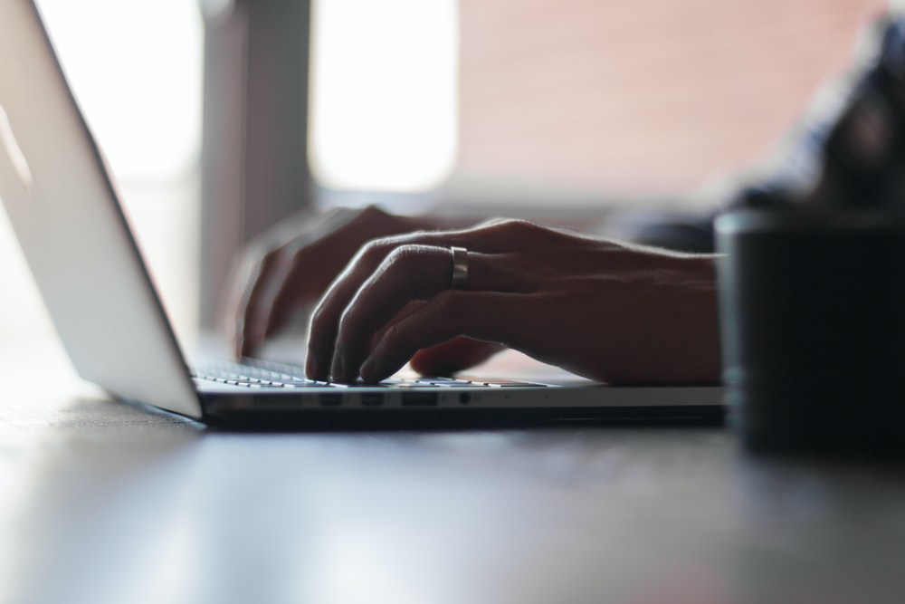 Seo Guide post man sitting at laptop typing