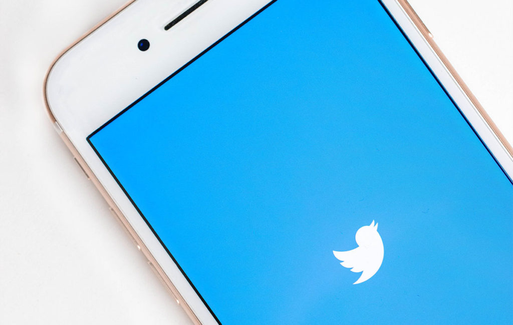 Twitter logo on phone screen blue