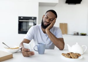 tired man doomscrolling through social media