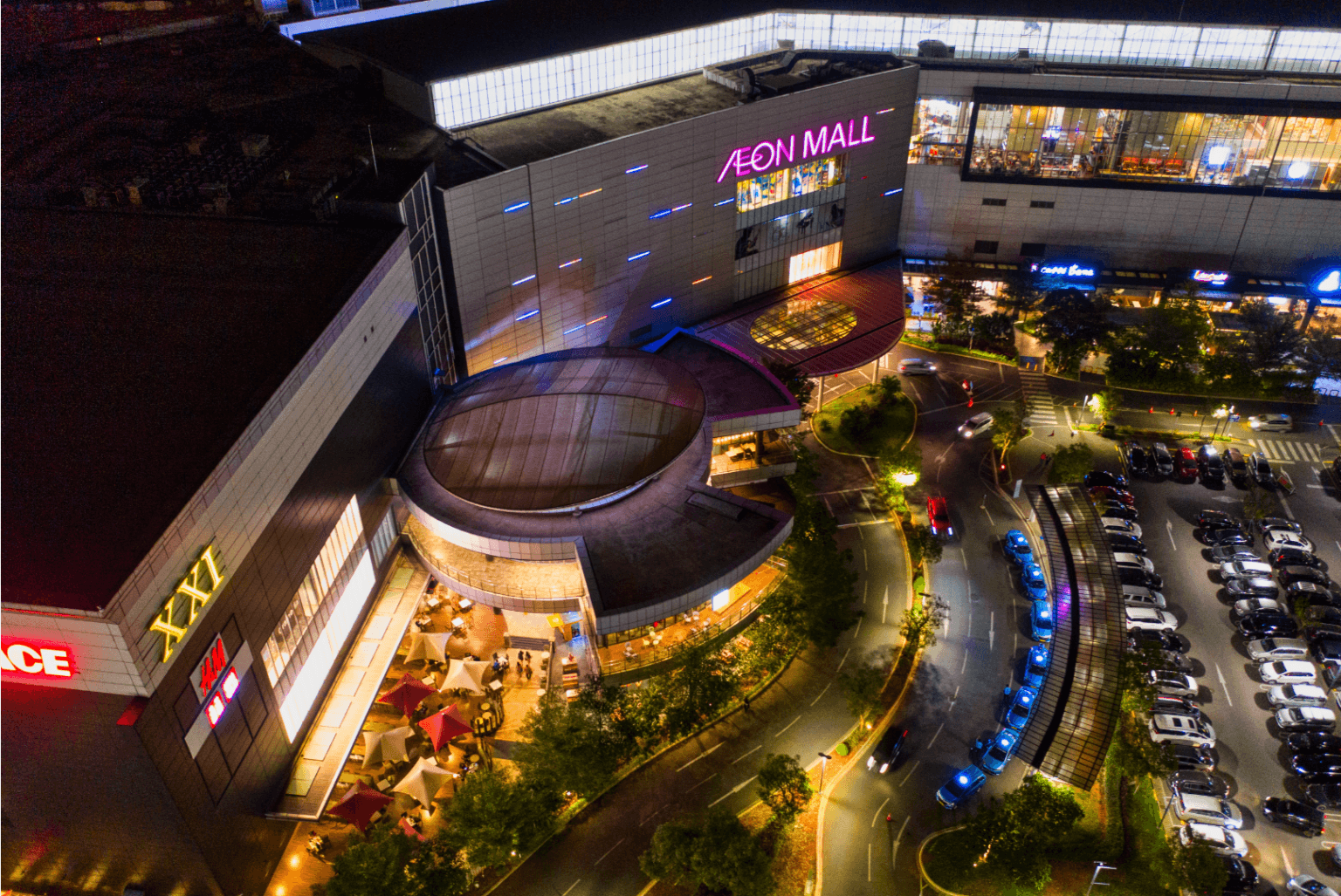 Aerial night photograph of a shopping mall exterior lit up, taken by drone in Doncaster
